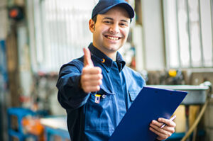 Happy mechanic holding clipboard