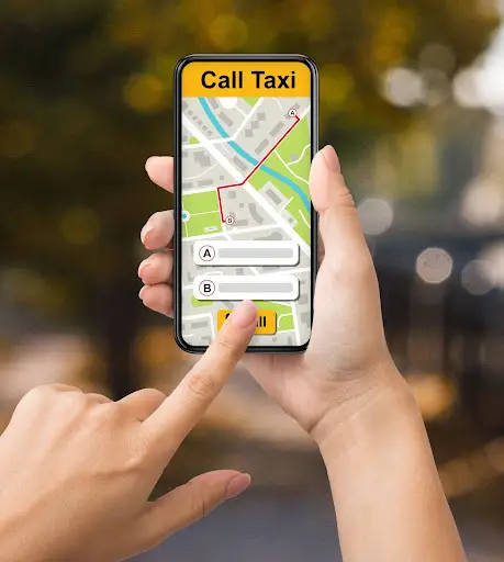 A person uses a smartphone app to call a taxi, entering pickup and drop-off locations on a map screen with a Call Taxi button at the top.